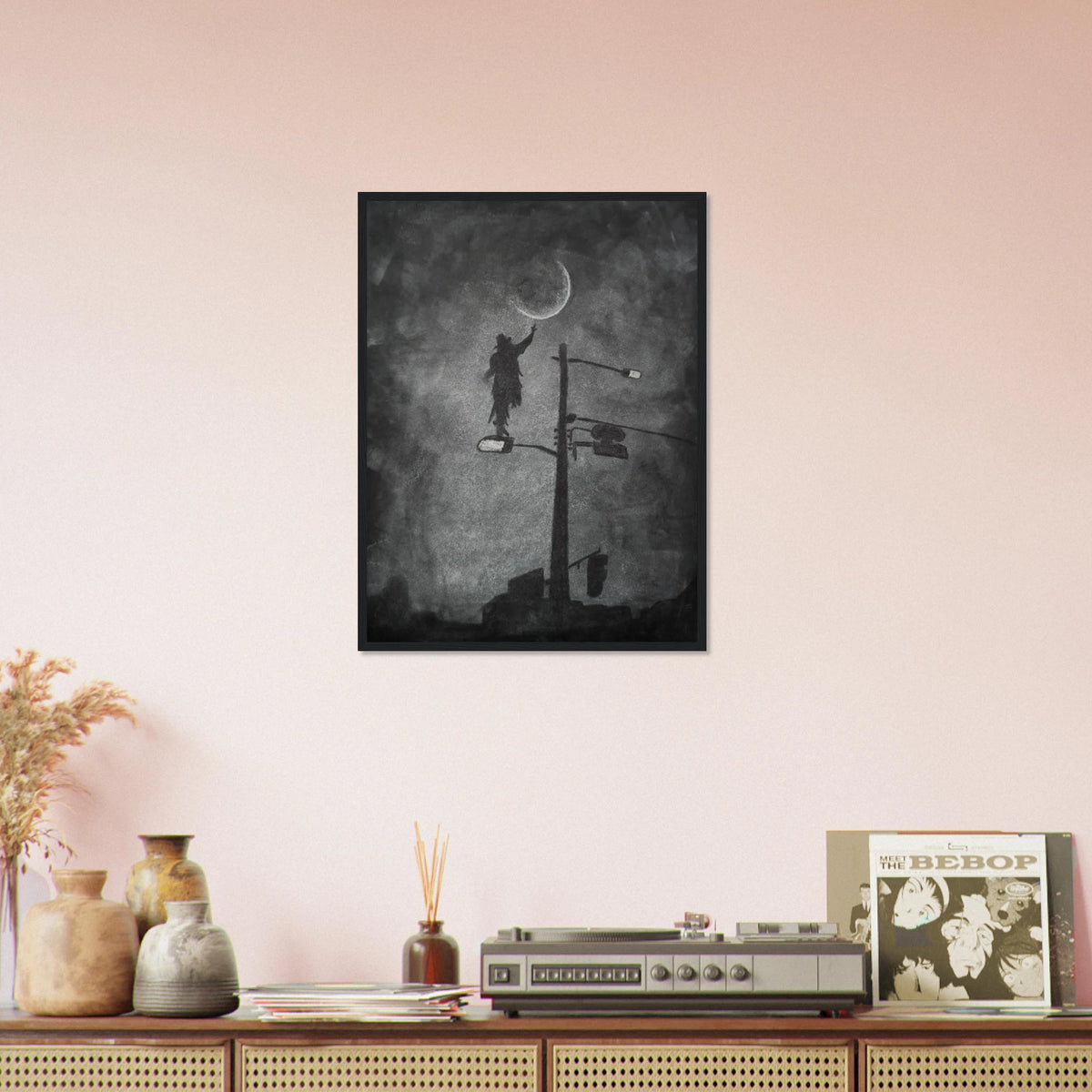 A beautiful white charcoal image of a man standing on a streetlight pole reaching for the moon.